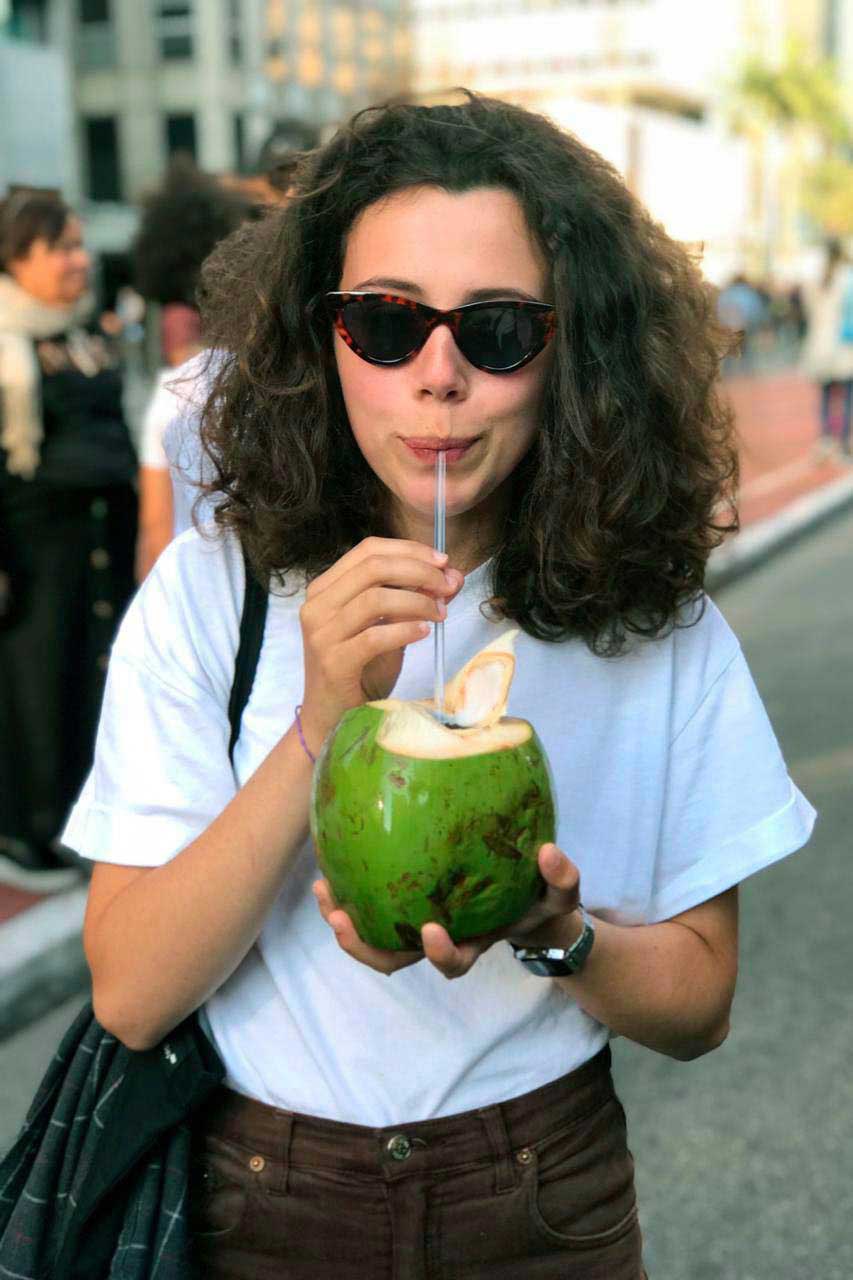Picture of Filipa drinking a Coconut Water.